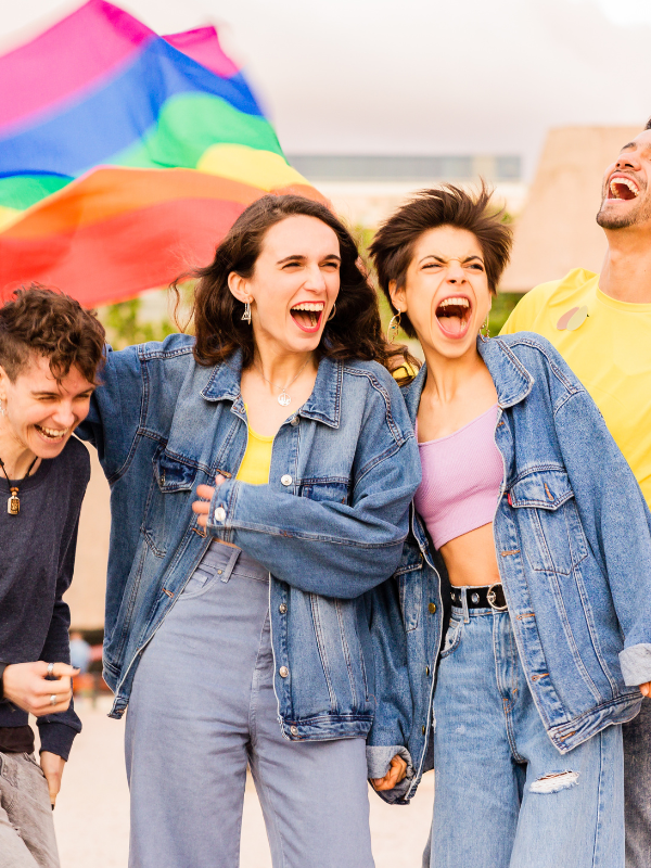 friends holding a rainbow flag